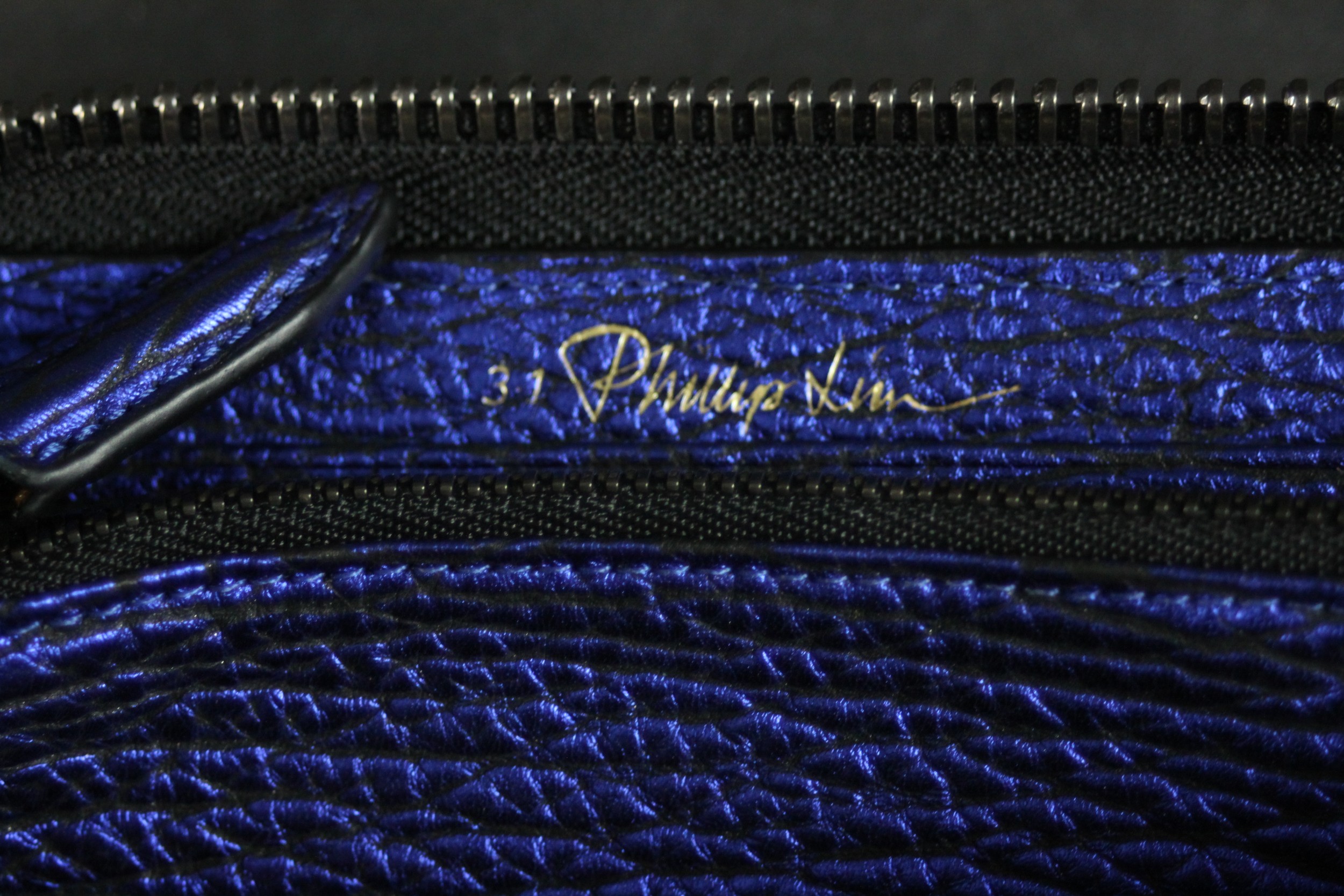 A vintage black silk Prada zip purse along with a Philip Lim metallic blue leather clutch bag. H. - Image 4 of 6