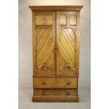 A Victorian Aesthetic movement pitch pine wardrobe, the two ecclesiastical style doors with