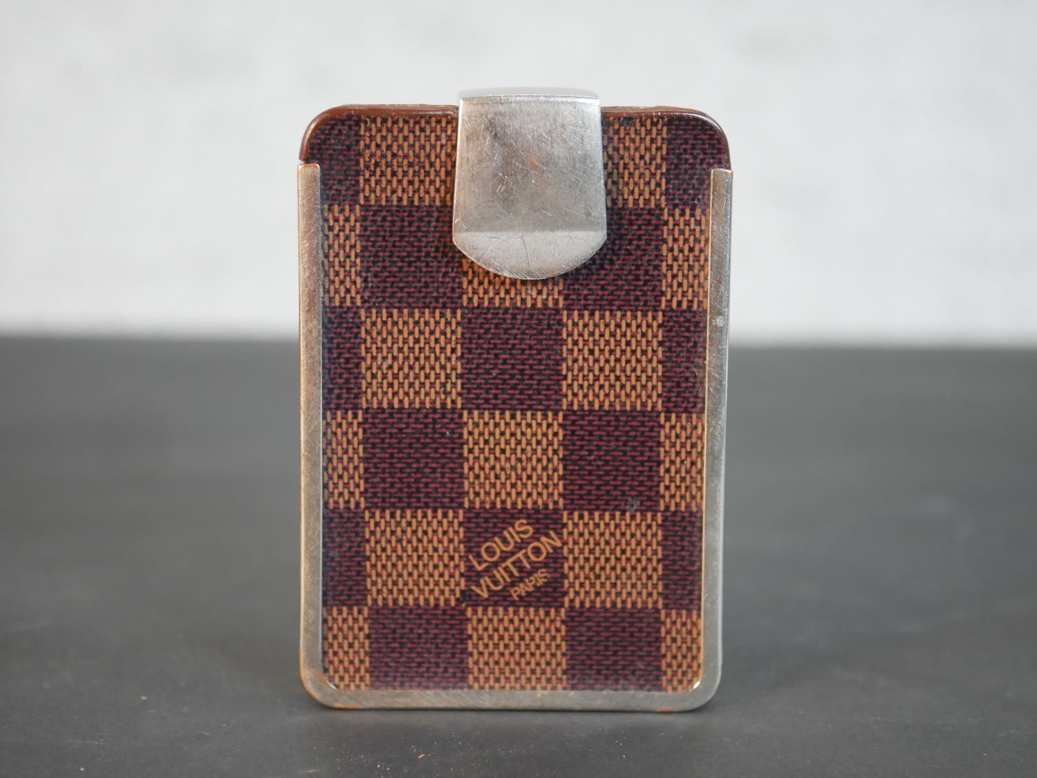 A vintage Louis Vuitton checkerboard design card holder with silver coloured metal hinge clasp and