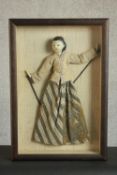 A framed and glazed fabric traditional Japanese puppet of a Geisha. H.50 W.54cm.