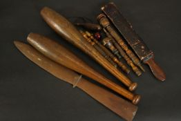 A collection of treen items, including two turned juggling clubs, needle cases, a page tuner,