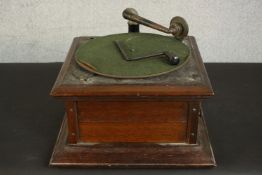 A Columbia oak Graphophone, with a winding arm and green baize turntable. H.27 W.40 D.40cm.