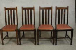 A set of four early 20th century oak dining chairs, with brown rexine drop in seats, on square