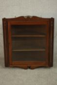 A 19th century walnut corner cabinet, the glazed door enclosing shelves. H.77 W.70 D.34cm