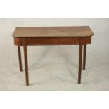 A George III mahogany D shaped console table, the top with a reeded edge on square section