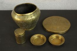 A collection of brass items, including a brass planter, gong and lidded pot with Egyptian design and