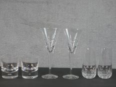 A collection of six crystal glasses, a pair of Dartington crystal highball glasses, stamps to