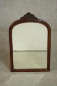 A late 19th / early 20th century walnut mirror, with a carved flowerhead crest. H.61 W.38cm.