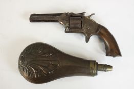 A engraved 19th century revolver along with a copper and brass 19th century repousse shell design