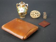 A leather cigar holder and miniature bible, carved soapstone egg, ceramic floral design scent bottle