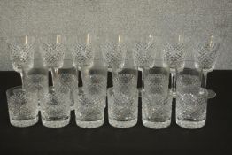 A collection of cut crystal drinking glasses, including a set of seven Waterford crystal cross hatch