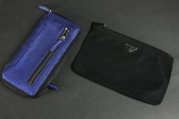 A vintage black silk Prada zip purse along with a Philip Lim metallic blue leather clutch bag. H.