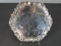 A 18th century Georgian silver scalloped edged card tray on three paw feet with shell motifs to