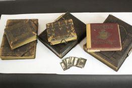 A collection of six embossed gilded leather covered Victorian photo albums along with a set of black