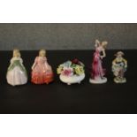 Four hand painted ceramic figures and a flower basket, three by Royal Doulton. Maker's marks to