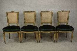 A set of four French Louis XVI style painted dining chairs, 19th century, with a caned back over a