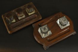 Two Victorian desk stands with cut glass ink wells, mahogany bases and lids. (One cracked pot and