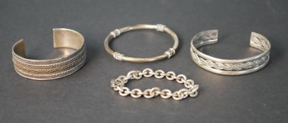 Four silver bracelets, including two silver cuff bangles with plaited rope design, a Chinese