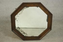 An early 20th century oak octagonal mirror. H.76 W.76cm.