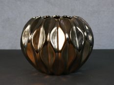 A bronze ceramic glaze stylised floral design table lamp. H.19 W.22cm