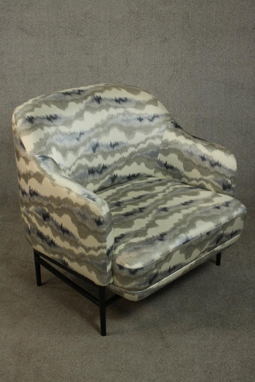 A pair of retro styled armchairs, with patterned upholstery in hues of grey, on a black powder - Image 11 of 13