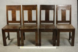 A set of four contemporary hardwood dining chairs, with solid seats on square section legs joined by