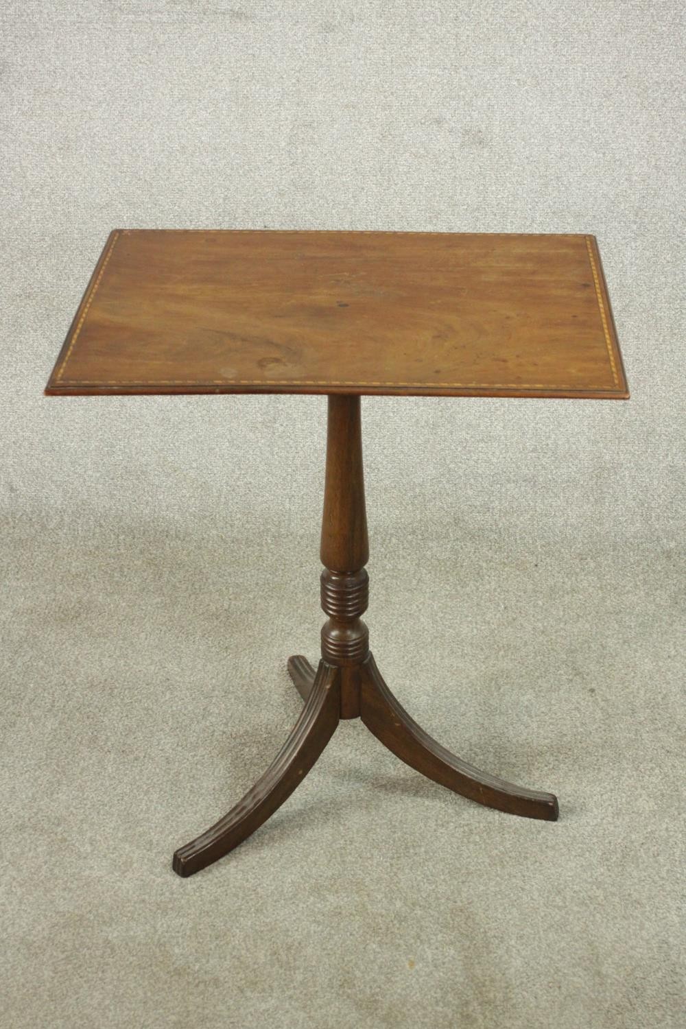 A 19th century walnut occasional table, the rectangular top with inlaid border, on a turned stem