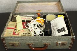 A vintage suitcase containing a Super 8 Elmo camera and various accessories. H.18 W.9 D.25cm.