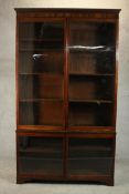 A Victorian walnut bookcase, with a pair of glazed doors enclosing shelves, over two further