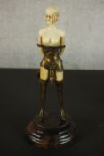 An Art Deco style bronze and cream resin figure of 'The Whip Girl' after Bruno Zach. H.33 W.14 D.