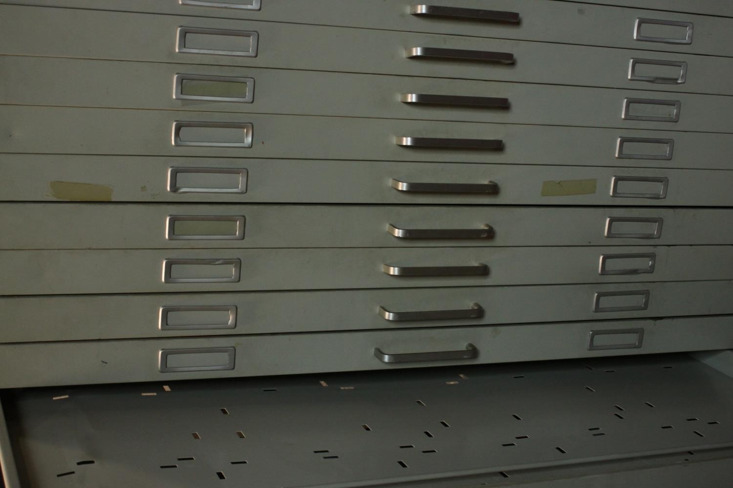 A grey painted steel plan chest, mid 20th century, with ten long drawers. H.87 W.137 D.100cm. - Image 4 of 7