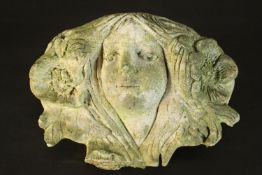 A concrete wall planter in the form of a an Art Nouveau female head with flowers in her hair. H.20