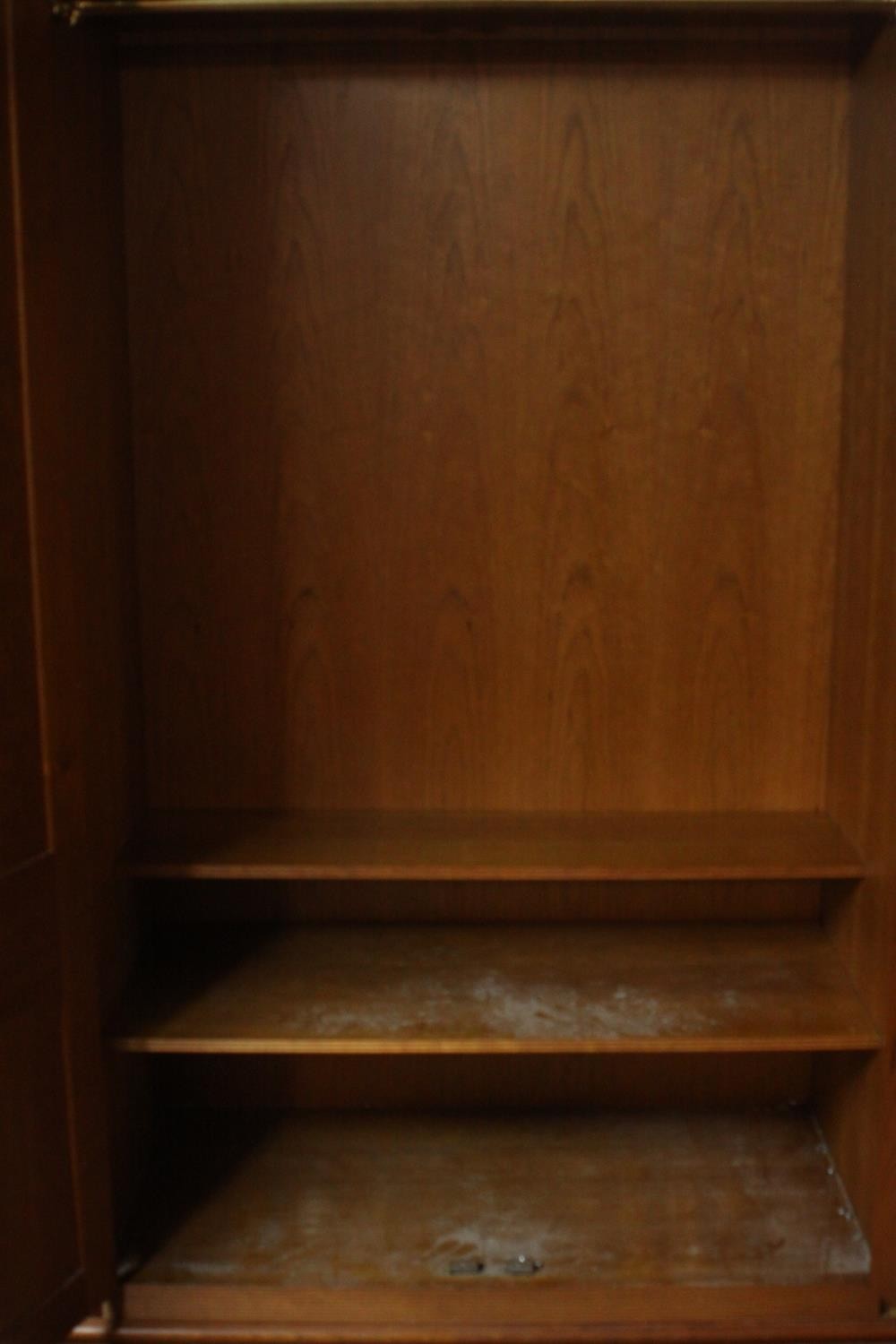 A late 20th century cherrywood wardrobe, with a pair of panelled doors opening to reveal hanging - Image 5 of 13