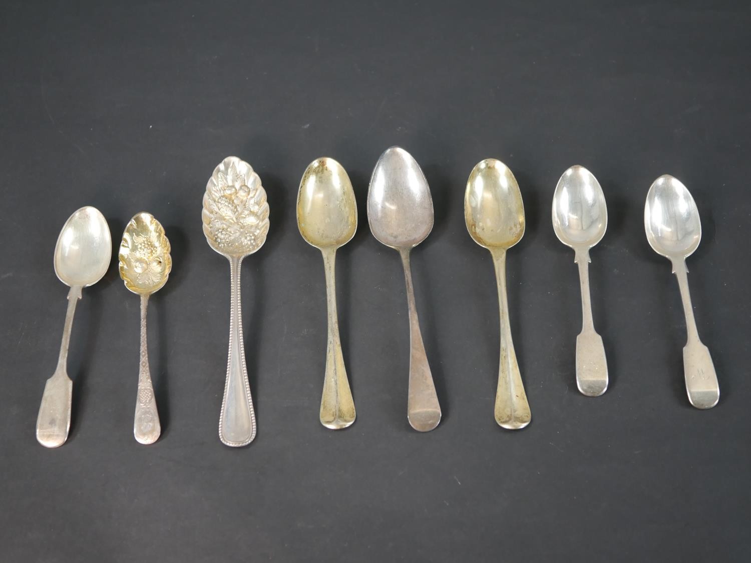 A collection of 18th and 19th century silver and silver plated spoons including a Georgian gilded