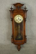 A Victorian figured walnut Vienna regulator wall clock, with turned finials and Roman numerals to