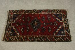 A Turkish Doshemolti rug with central medallion on a burgundy ground within stepped spandrels. H.123