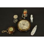 Two barometers, a vintage compass, bisque porcelain figure and a Bavarian painted nut cracker. H.3