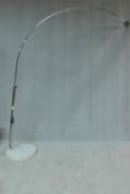 A chromium floor standing arc lamp on marble base, lacks shade. H.210 W.45 D.45cm