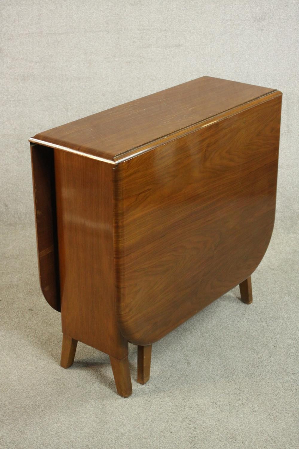 A mid 20th century walnut drop leaf dining table, the two leaves with rounded corners on a base with - Image 7 of 9