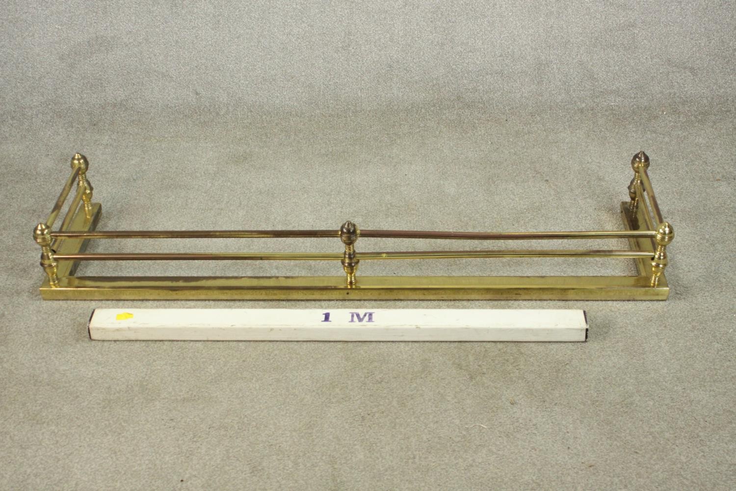 A Victorian brass fender of typical form with ball supports to the tubular rails. H.18 W.134 D.36cm. - Image 2 of 5