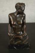 An Art Deco style bronze resin figure of a nude female bust, mounted on a white veined black