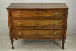 A 19th century French fruitwood commode chest of three long drawers on turned legs. H.87 W.119 D.