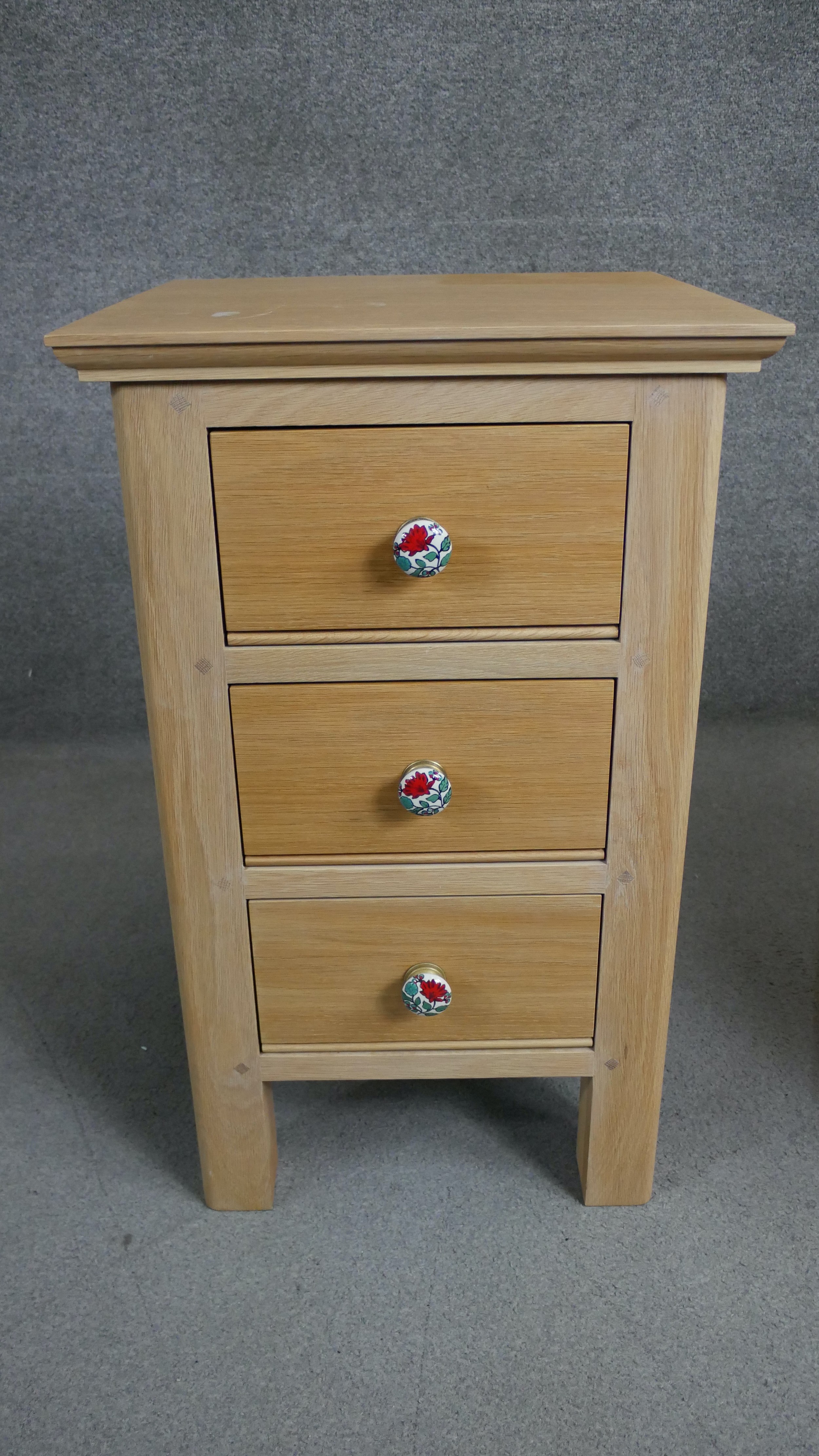 A pair of contemporary oak bedside chests each with three drawers and painted floral handles. H.73 - Image 3 of 4