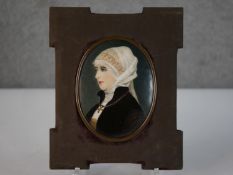 A 19th century framed hand painted porcelain plaque with a portrait of a religious female figure.