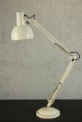 A Herbert Terry style white painted anglepoise desk lamp, on a circular weighted base. H.104 Dia.