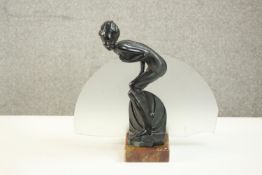 An Art Deco spelter bather figural lamp on marble base with frosted disc shade. (Glass disc