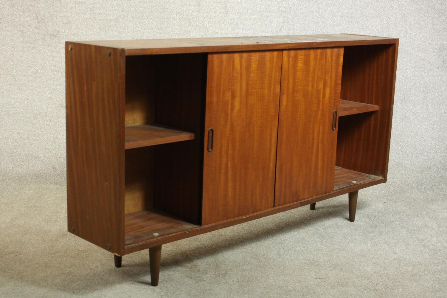 A circa 1960s teak sideboard, fitted with shelves and two sliding doors, on tapering cylindrical - Image 5 of 8