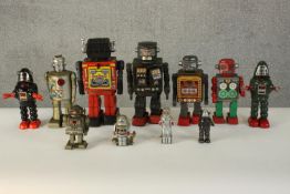 A collection of eleven wind up vintage tin Japanese plate toy robots. Various makers. H.30 W.10 D.