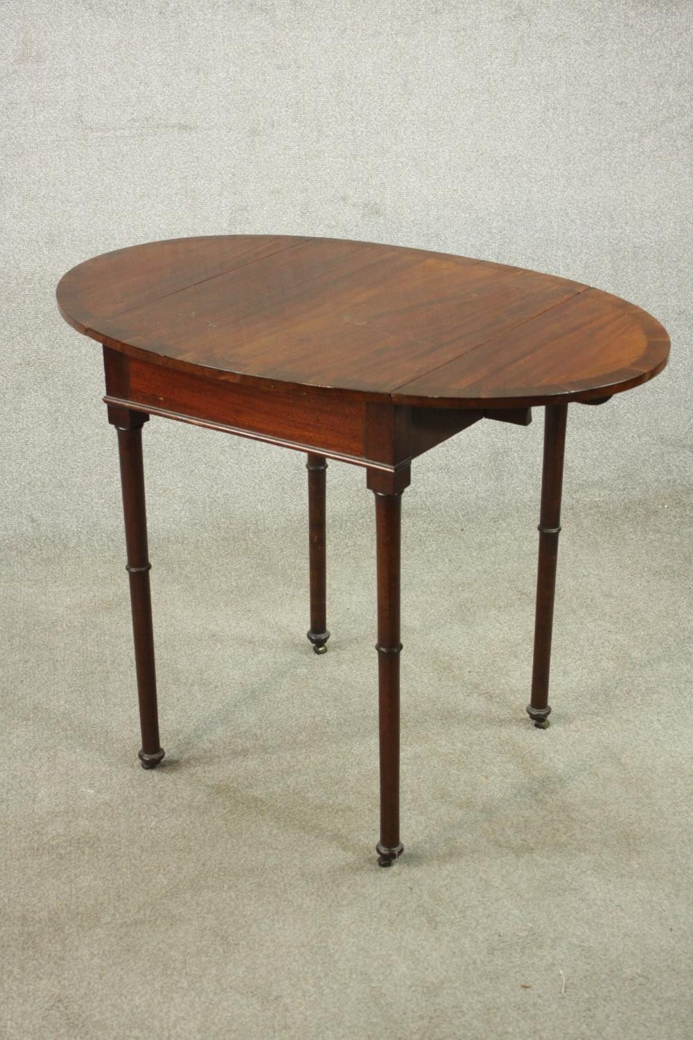 A mahogany drop leaf Pembroke style table, the oval top with a crossbanded edge, on turned legs. H. - Image 6 of 10