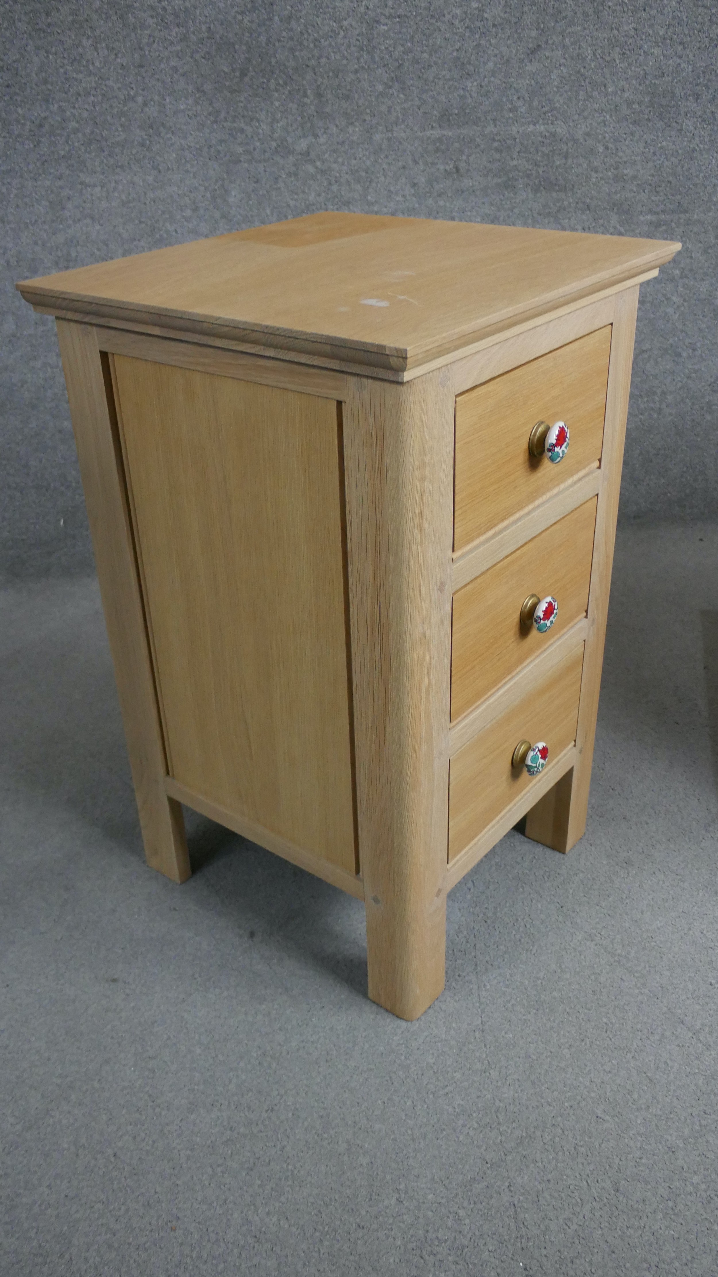 A pair of contemporary oak bedside chests each with three drawers and painted floral handles. H.73 - Image 4 of 4
